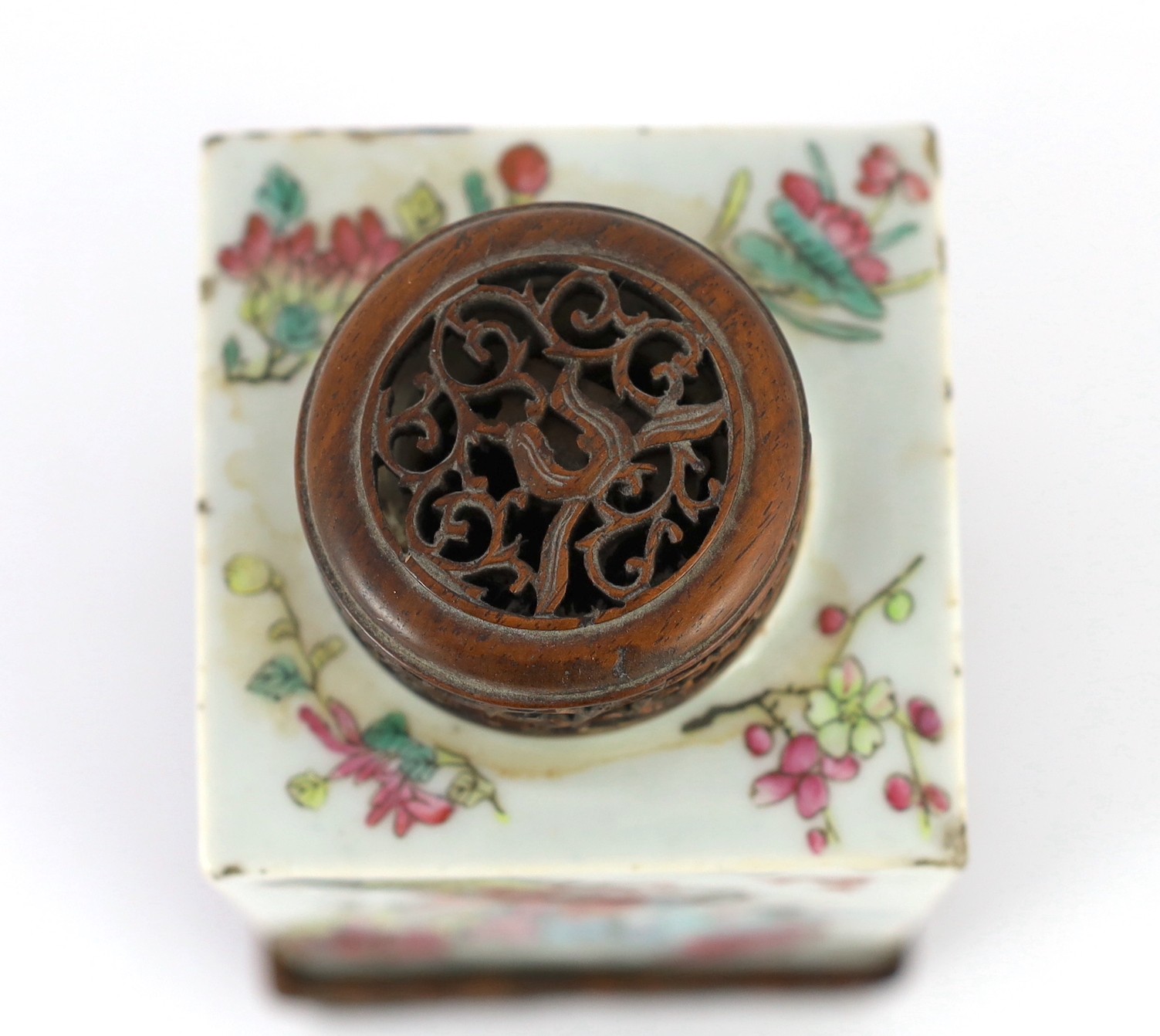 A Chinese famille rose square tea caddy, mid 19th century, 13.7cm high excluding wood stand and cover, slight damage